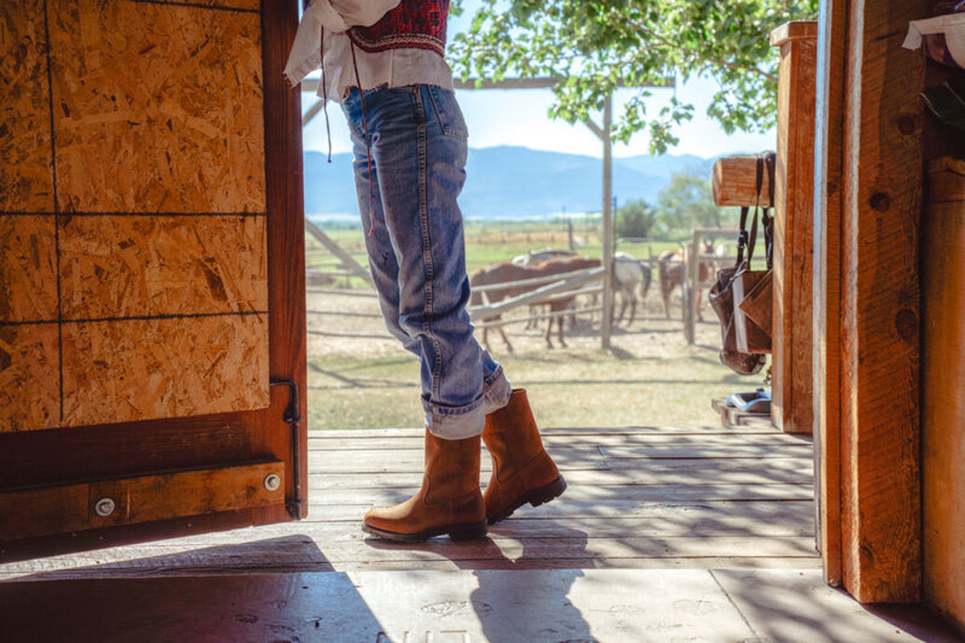 woman standing at a barn door wearing jeans and blundstone 2527 boots 