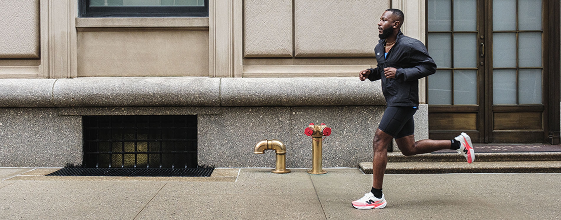 A group of runners smiles and all, running through a cityscape and having a good time