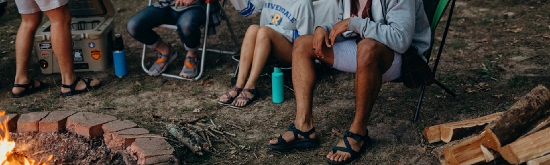 Group of friends sitting around a campfire